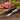 Dark Ash steak with fork and knife set on wooden board