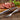 Walnut knife and fork with steak on wooden board