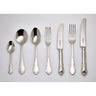 Set of cutlery including spoons, forks, and knives on a gray background